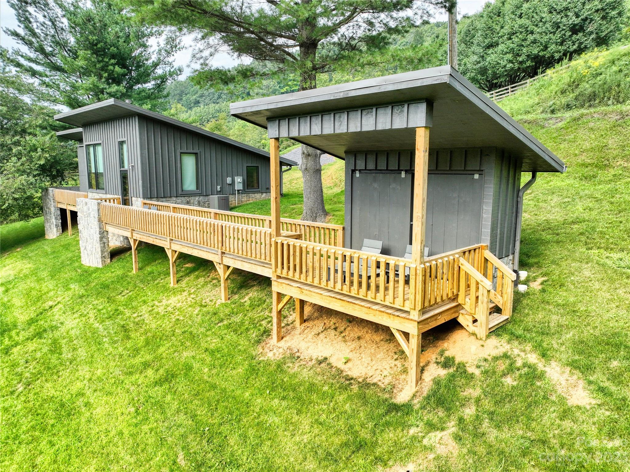 3765 Bald Mountain Road, Unit 2 West Jefferson, NC 28694 - Photo 18 of 35 a view of a house with a yard and deck area