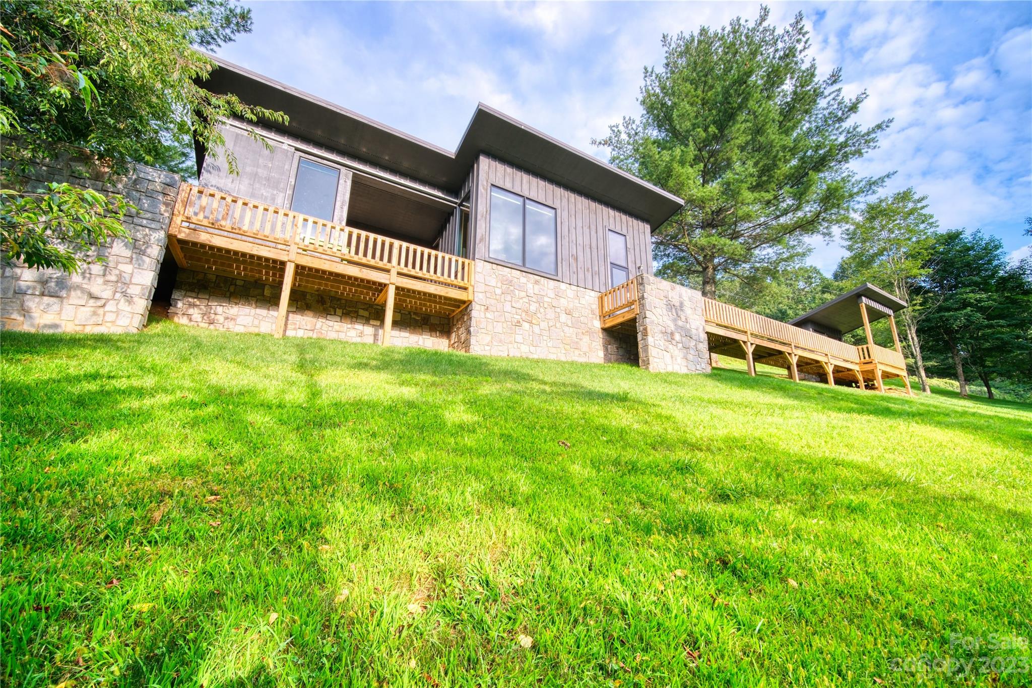 3765 Bald Mountain Road, Unit 2 West Jefferson, NC 28694 - Photo 21 of 35 a view of a house with a yard and sitting area