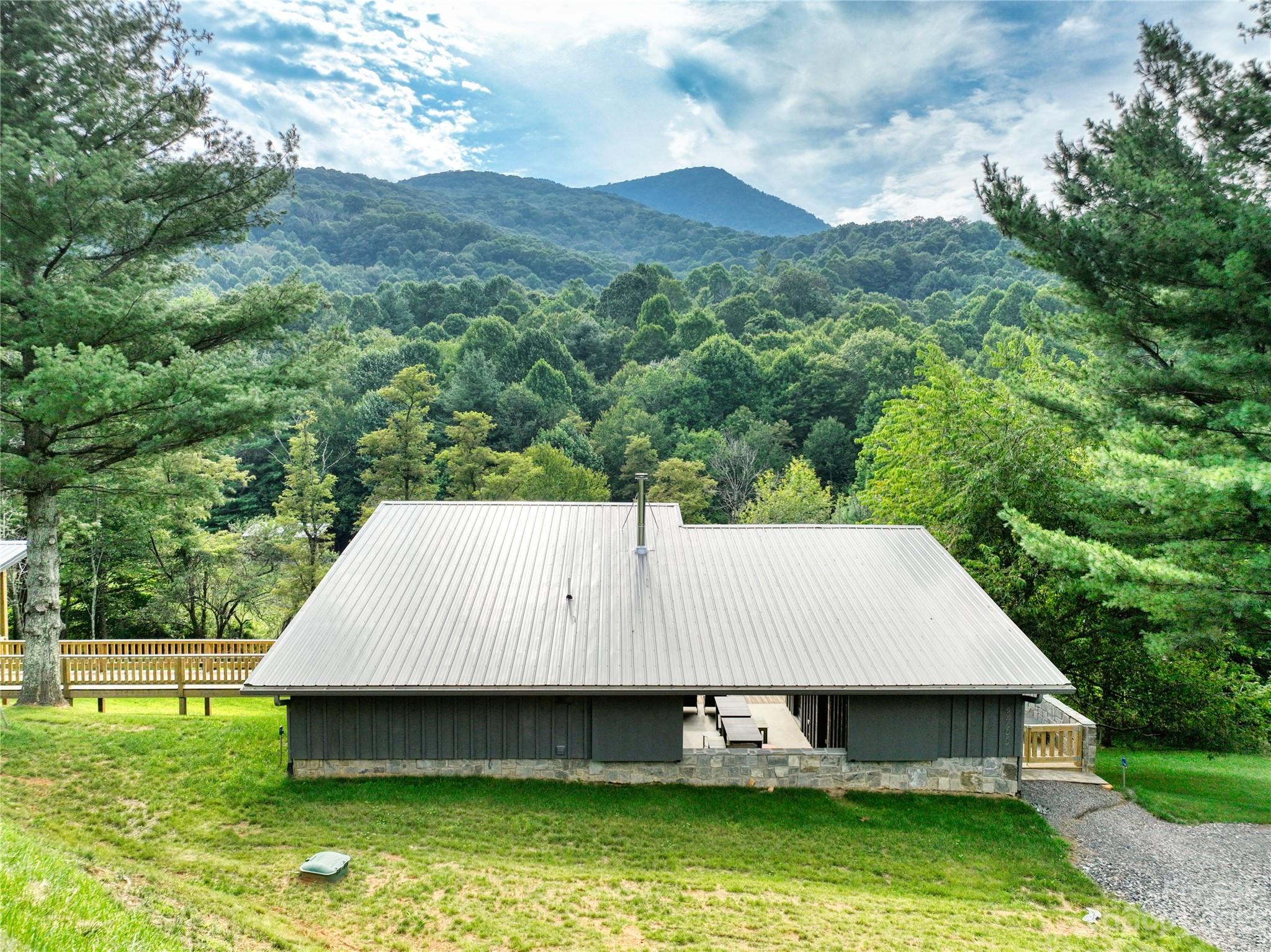 3765 Bald Mountain Road, Unit 2 West Jefferson, NC 28694 - Photo 22 of 35 a view of a wooden deck and a yard with green space