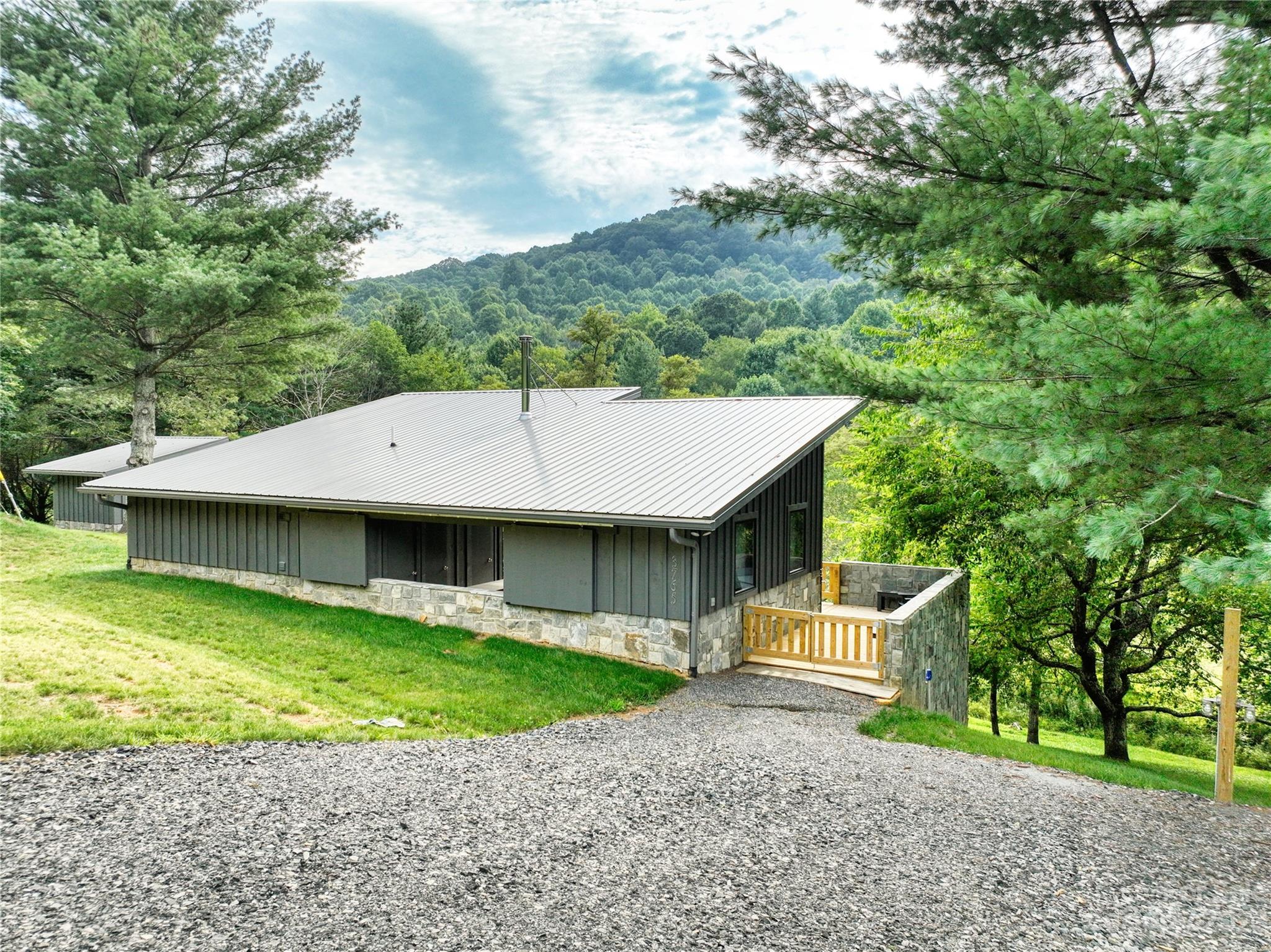 3765 Bald Mountain Road, Unit 2 West Jefferson, NC 28694 - Photo 23 of 35 a view of a house with a yard and large tree
