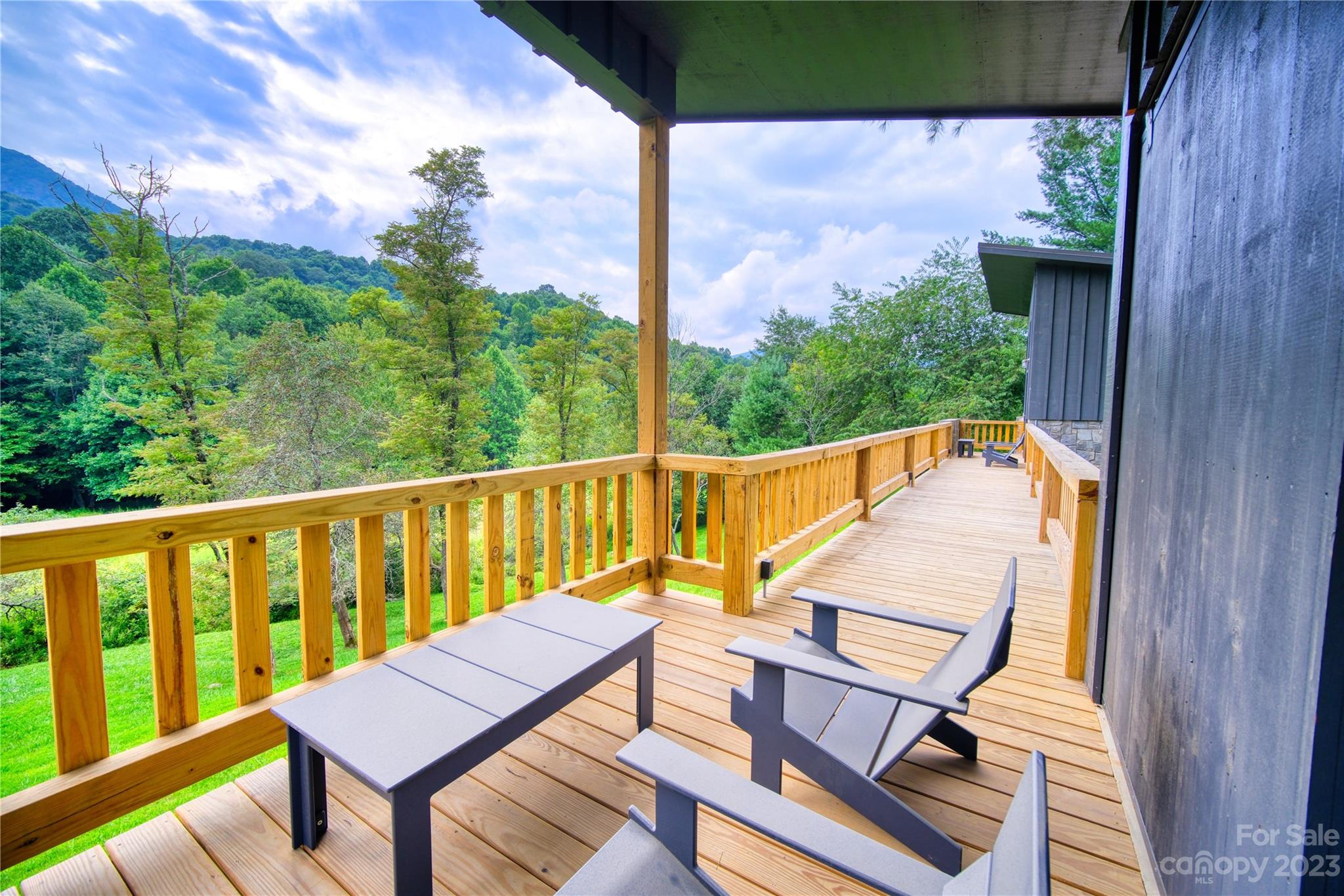 3765 Bald Mountain Road, Unit 2 West Jefferson, NC 28694 - Photo 27 of 35 a view of a balcony with wooden floor and outdoor seating