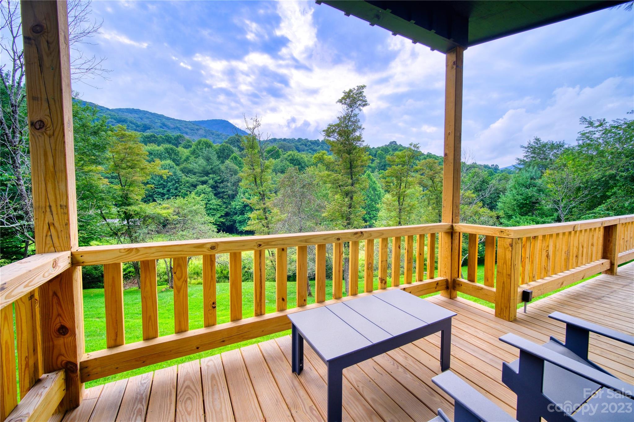 3765 Bald Mountain Road, Unit 2 West Jefferson, NC 28694 - Photo 4 of 35 a view of a wooden deck with a bench