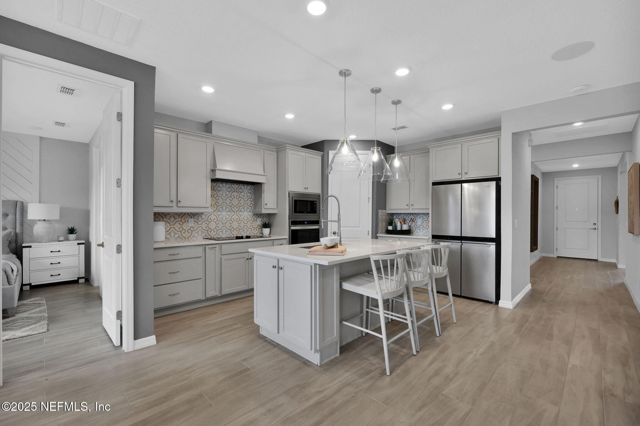1710 Mickey Way Middleburg, FL 32068 - Photo 5 of 20 a kitchen with white cabinets and stainless steel appliances