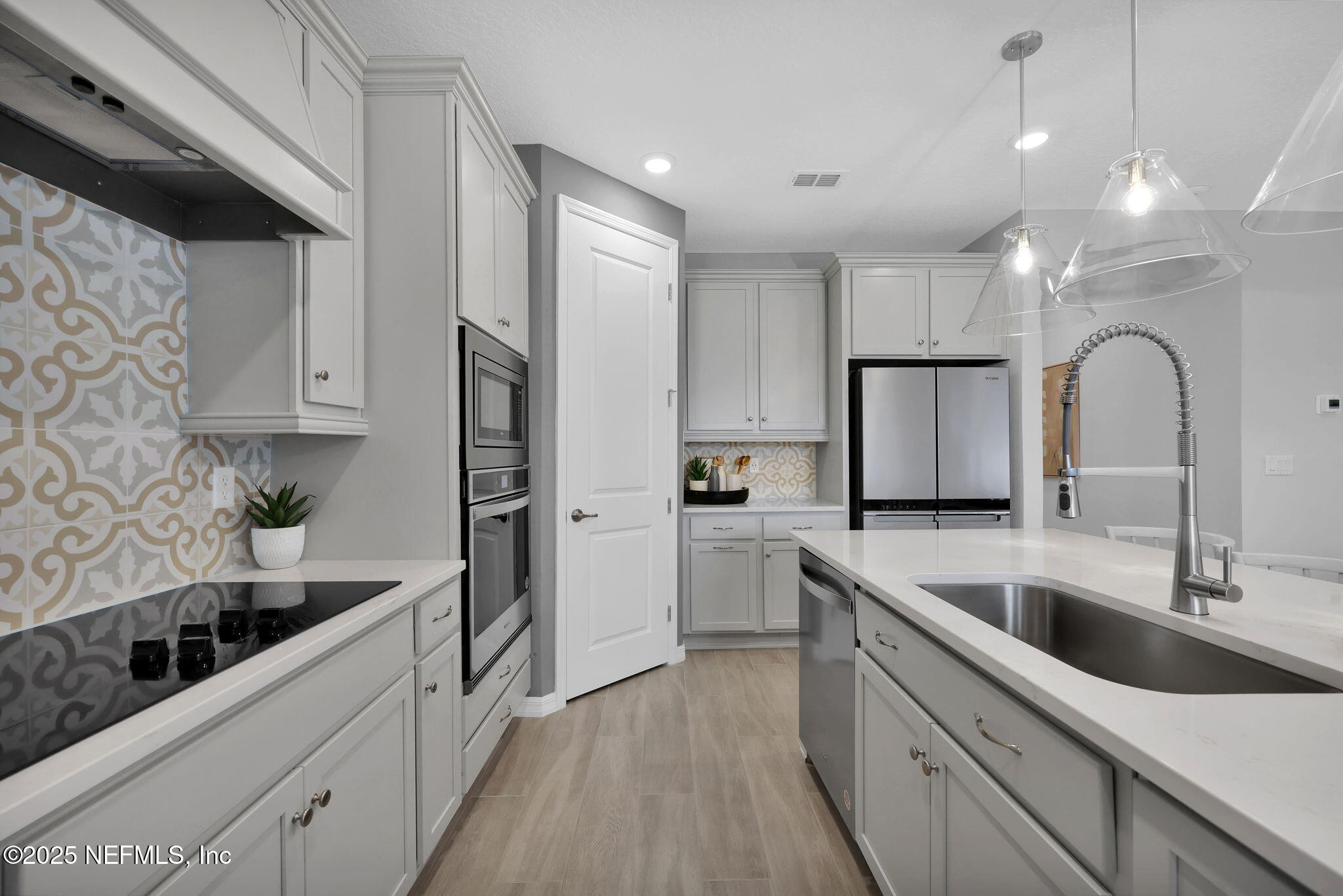1710 Mickey Way Middleburg, FL 32068 - Photo 7 of 20 a kitchen with white cabinets a sink stove and refrigerator