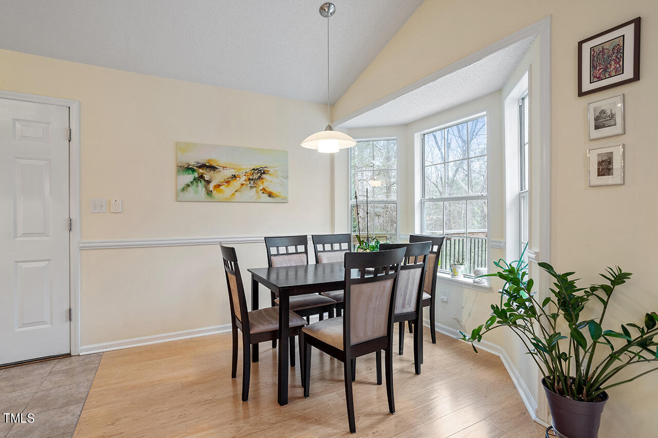 4437 Labrador Drive Raleigh, NC 27616 - Photo 12 of 25 a view of a dining room with furniture window and wooden floor