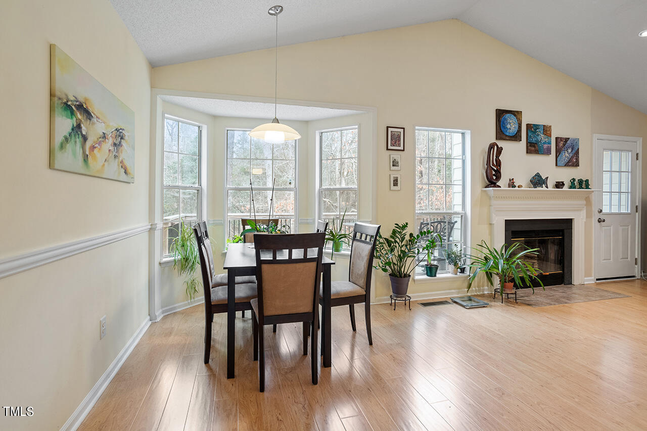 4437 Labrador Drive Raleigh, NC 27616 - Photo 13 of 25 a view of a dining room with furniture window and wooden floor