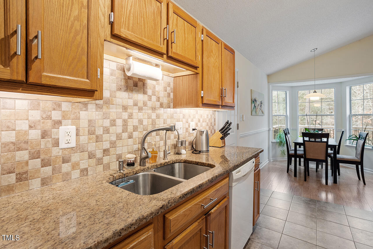 4437 Labrador Drive Raleigh, NC 27616 - Photo 15 of 25 a kitchen with a sink cabinets and window