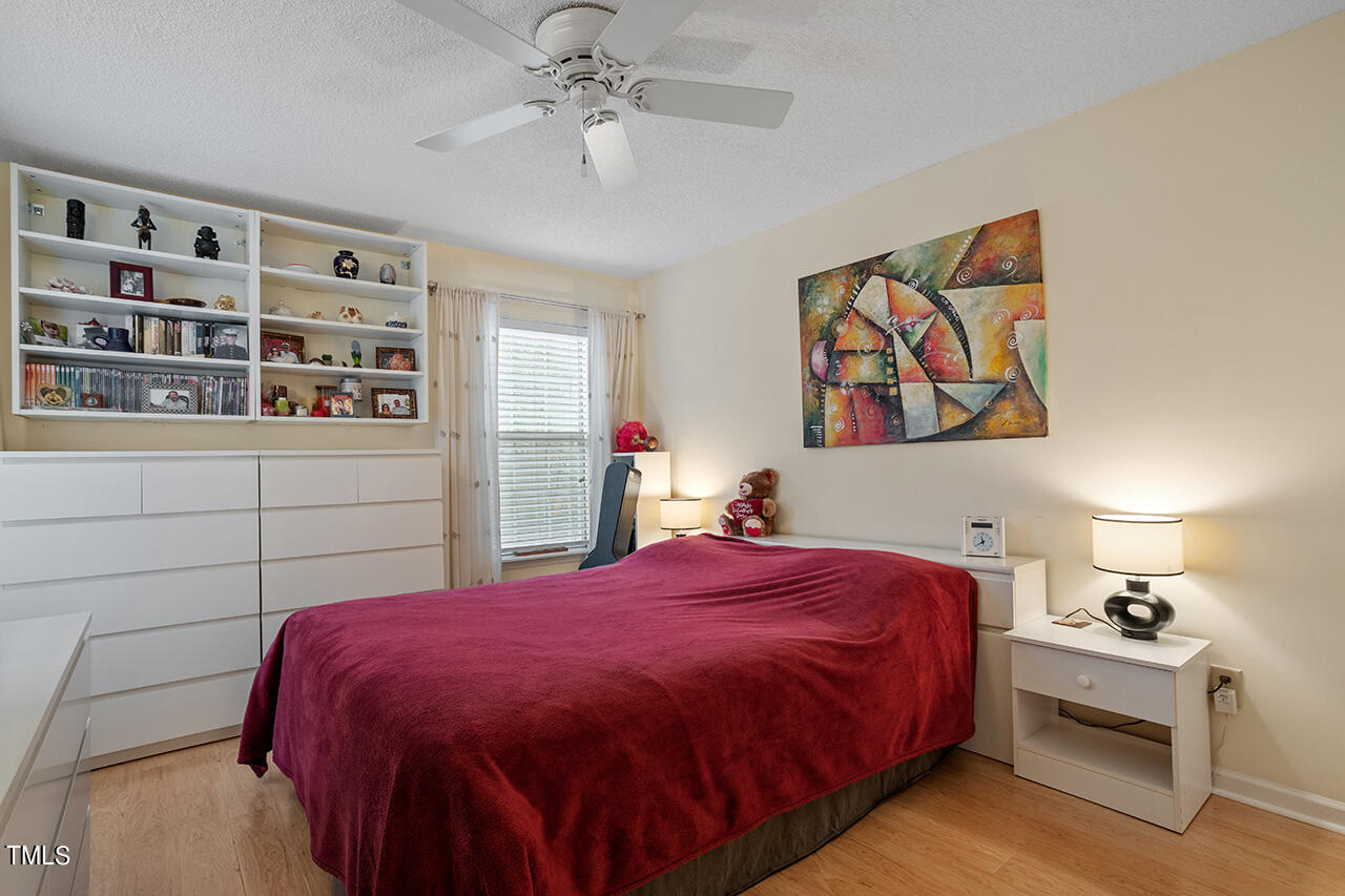 4437 Labrador Drive Raleigh, NC 27616 - Photo 17 of 25 a bedroom with a bed and a chandelier