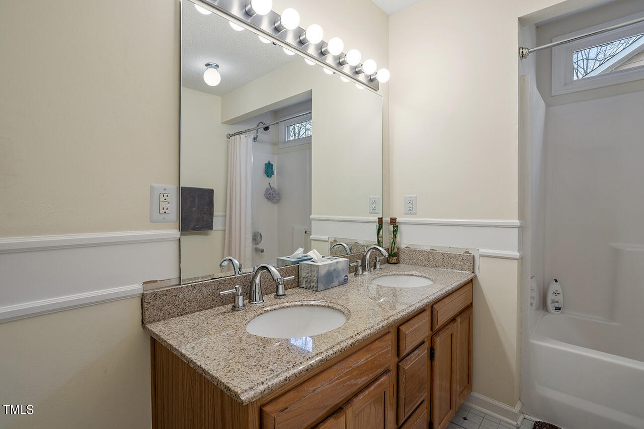 4437 Labrador Drive Raleigh, NC 27616 - Photo 20 of 25 a bathroom with a granite countertop sink and a mirror