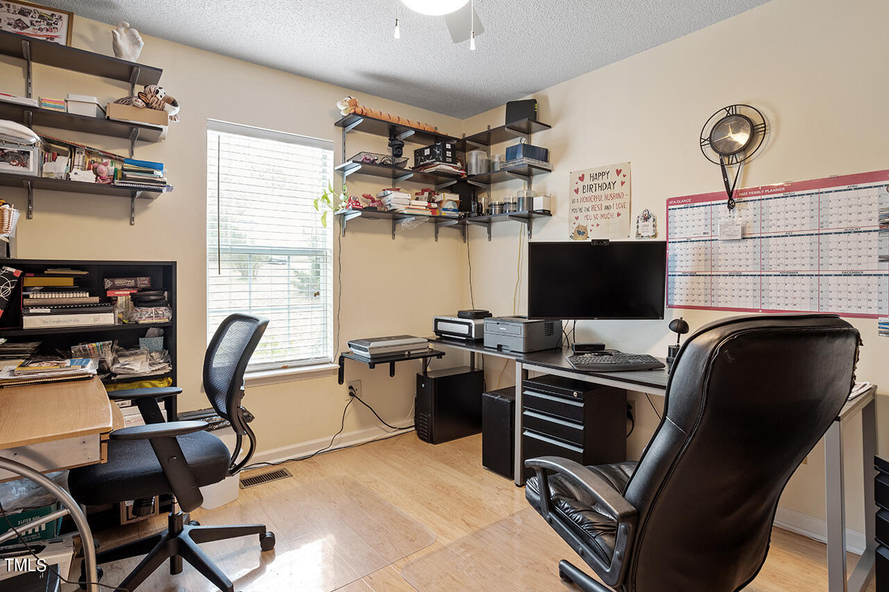 4437 Labrador Drive Raleigh, NC 27616 - Photo 22 of 25 a view of a workspace with furniture and a window
