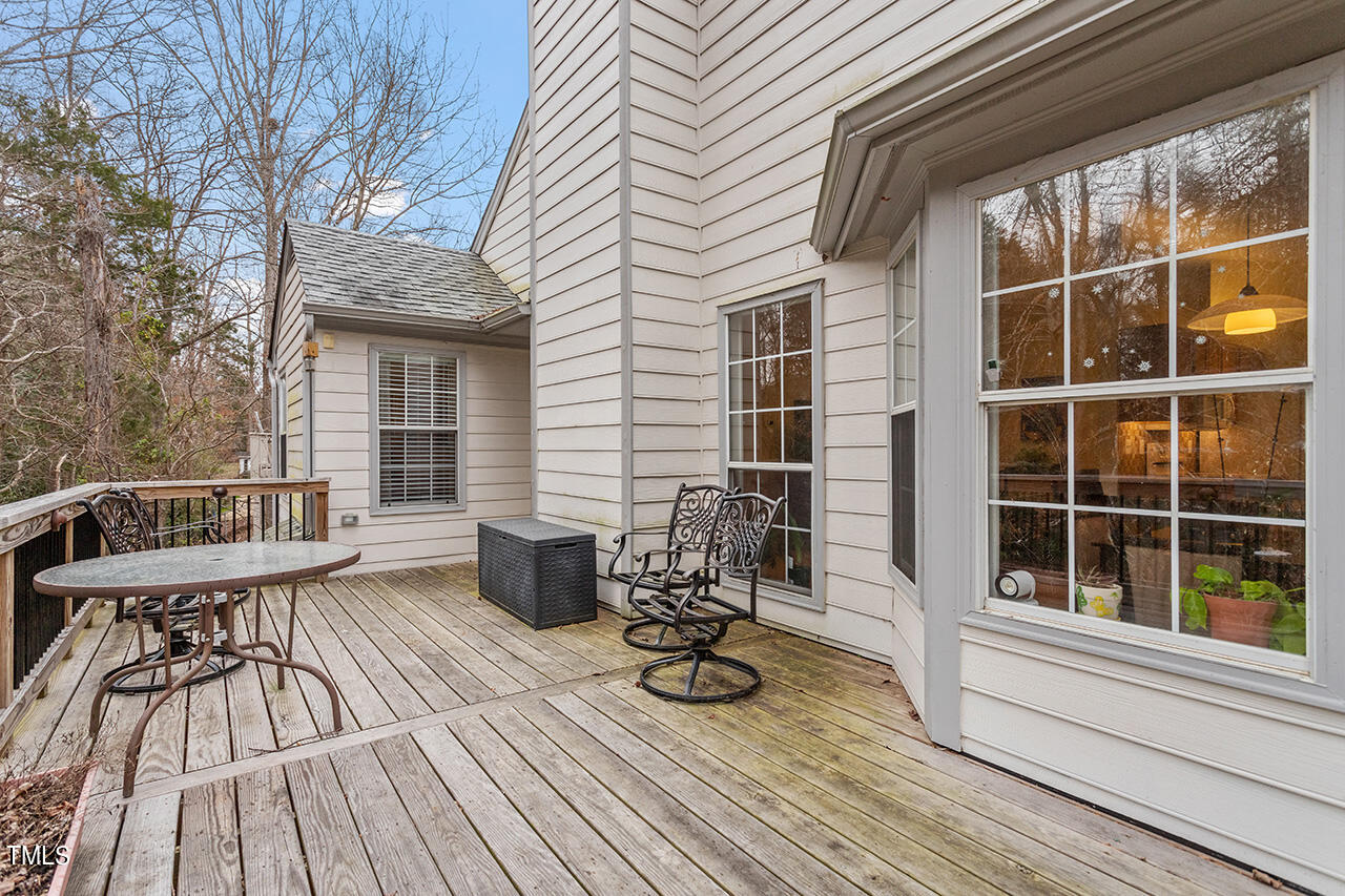 4437 Labrador Drive Raleigh, NC 27616 - Photo 5 of 25 a view of deck with table and chairs and wooden floor