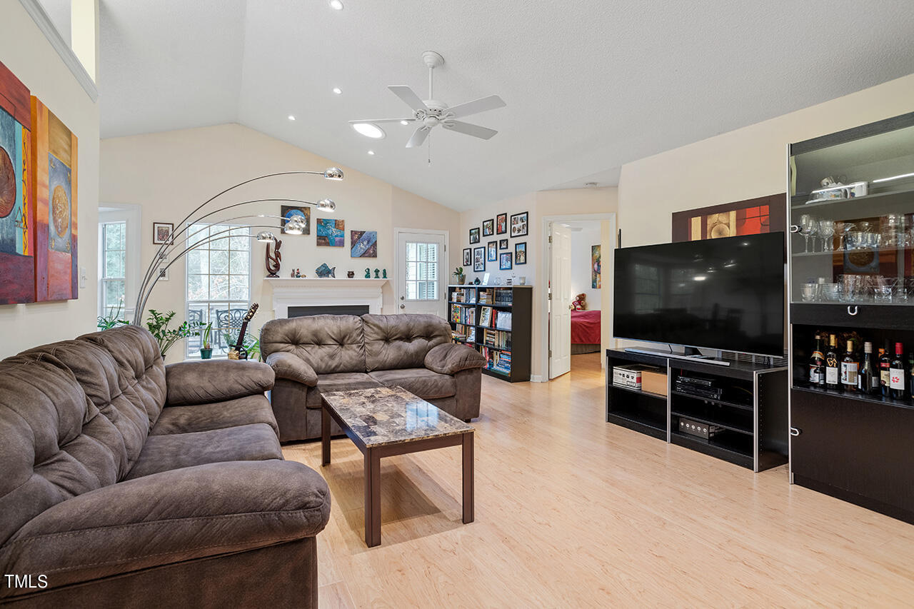 4437 Labrador Drive Raleigh, NC 27616 - Photo 6 of 25 a living room with furniture and a flat screen tv