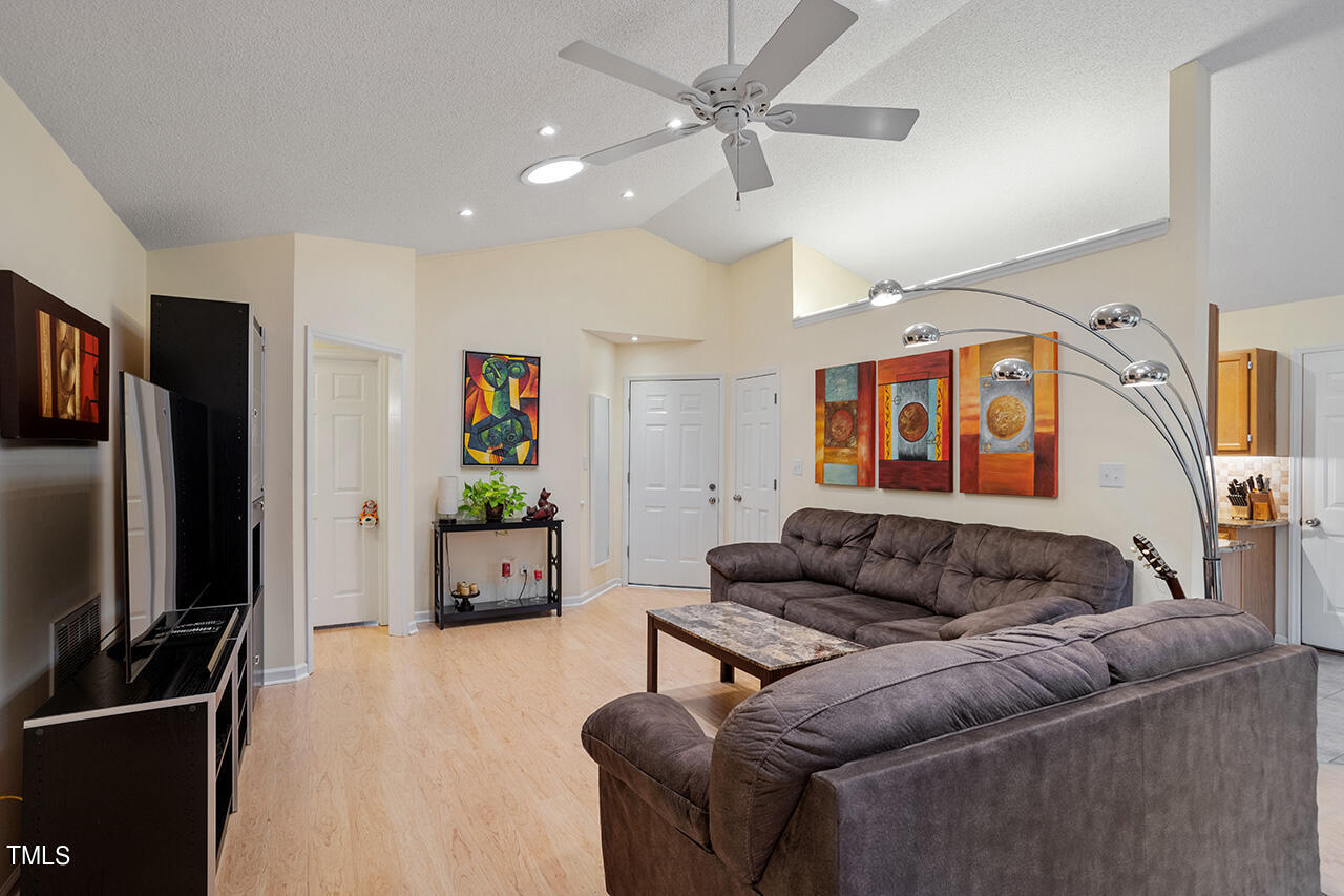 4437 Labrador Drive Raleigh, NC 27616 - Photo 9 of 25 a living room with furniture and a flat screen tv