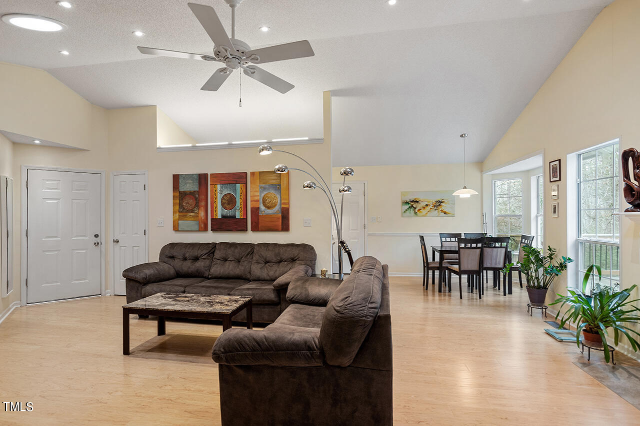 4437 Labrador Drive Raleigh, NC 27616 - Photo 10 of 25 a living room with furniture potted plant and a window