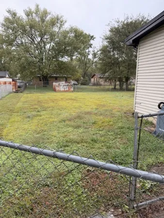 a view of a pool with lawn chairs