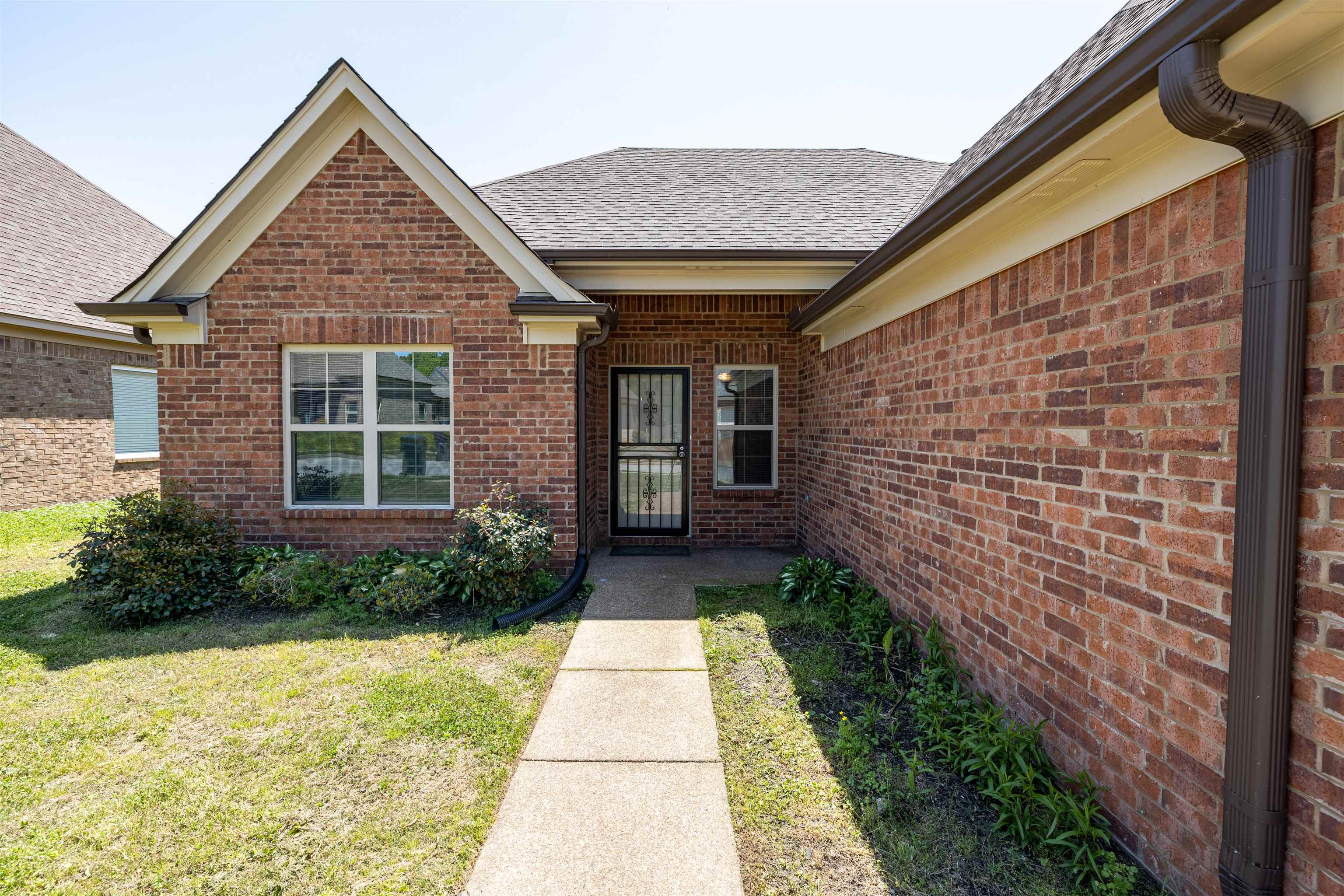 5262 Crossfield Road Memphis, TN 38109 - Photo 3 of 19 a front view of a house with garden
