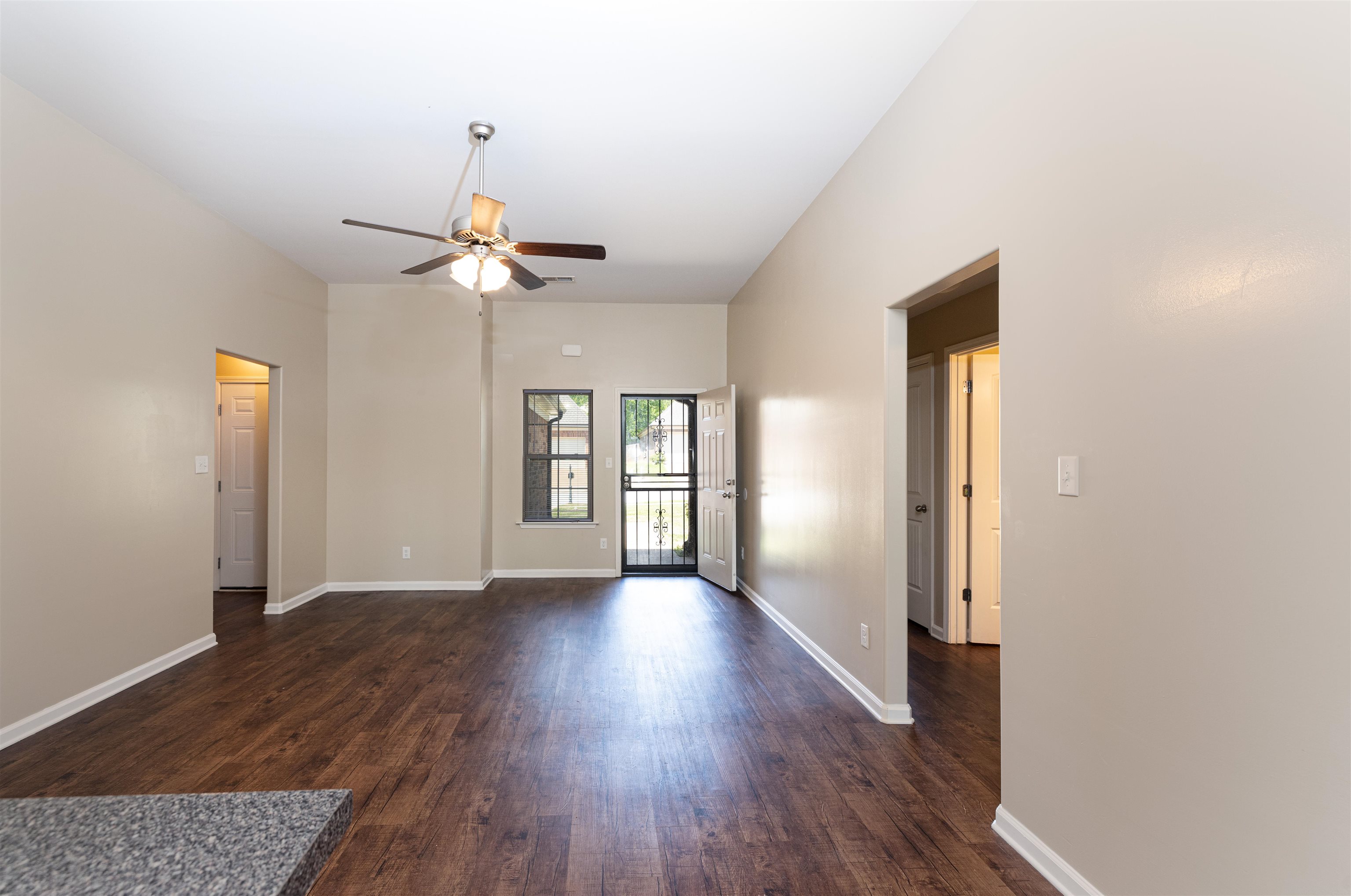 5262 Crossfield Road Memphis, TN 38109 - Photo 5 of 19 wooden floor in an empty room with a window