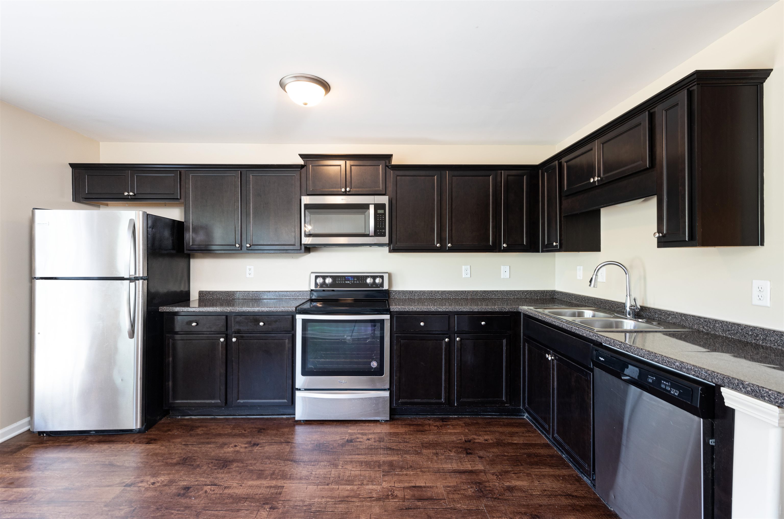 5262 Crossfield Road Memphis, TN 38109 - Photo 6 of 19 a kitchen with stainless steel appliances granite countertop a stove a sink dishwasher a refrigerator and a microwave oven