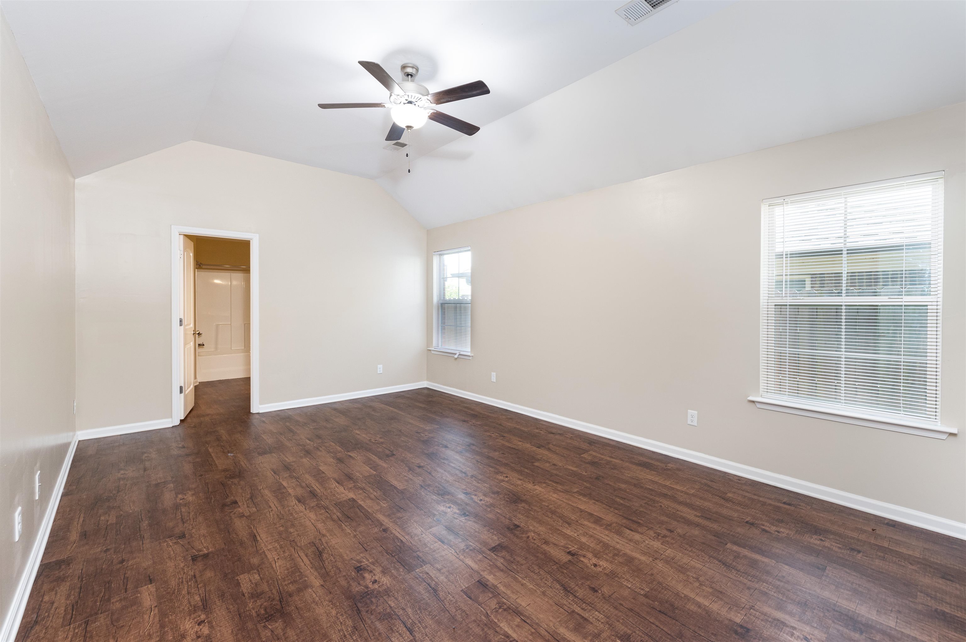 5262 Crossfield Road Memphis, TN 38109 - Photo 9 of 19 an empty room with wooden floor chandelier fan and windows