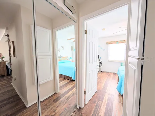 a bedroom with a bed and a flat tv screen on the dresser