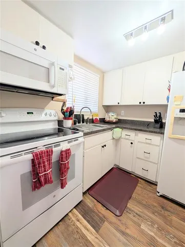 a kitchen with stainless steel appliances granite countertop a sink and cabinets