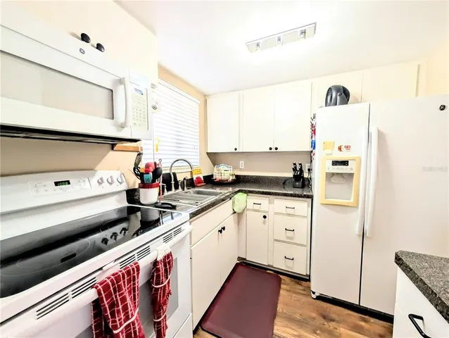a kitchen with stainless steel appliances a sink and a refrigerator