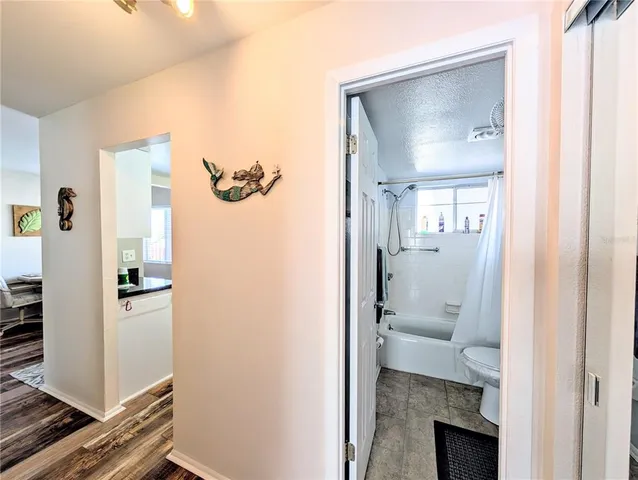 a bathroom with a toilet and a glass door