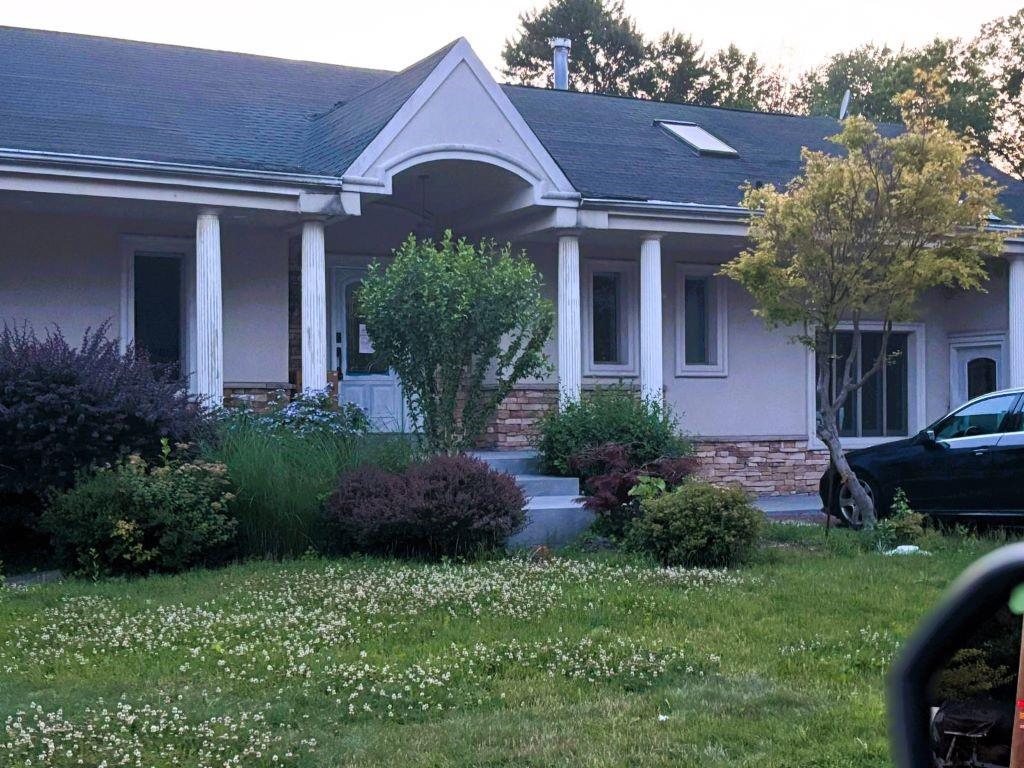 a front view of a house with a garden