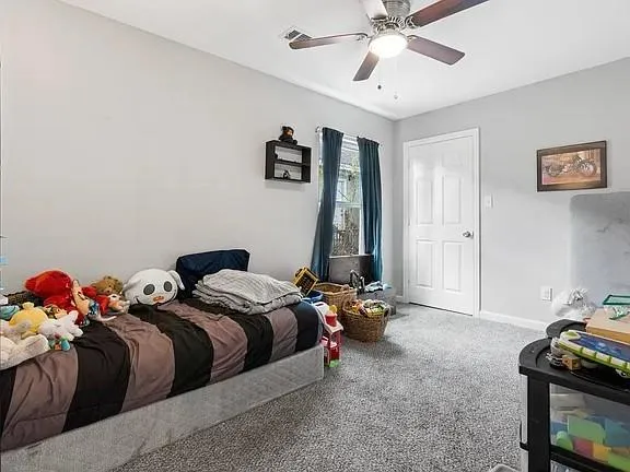 a bedroom with two beds and a chandelier
