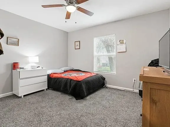 a room with a bed and a chandelier