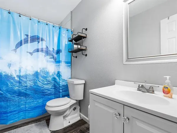 a white toilet sitting next to a bathroom sink