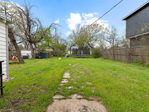 a view of a yard with large trees