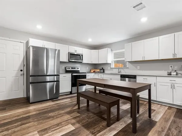 a kitchen with a refrigerator a stove a sink and a microwave