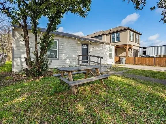 a view of a yard with a house and a bench