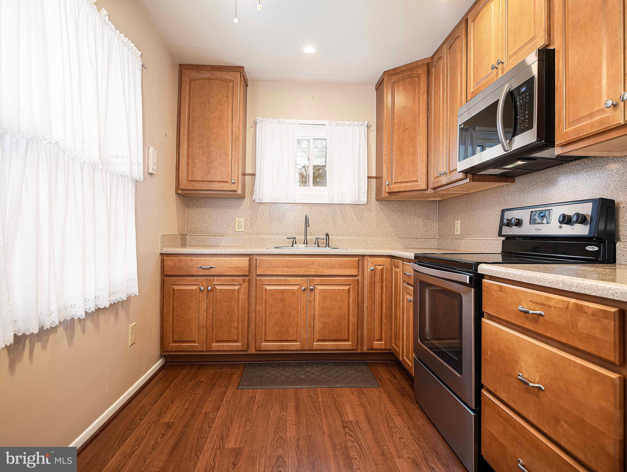 1131 Hollen Road Baltimore, MD 21239 - Photo 14 of 34 a kitchen with stainless steel appliances granite countertop a sink a stove a microwave and cabinets