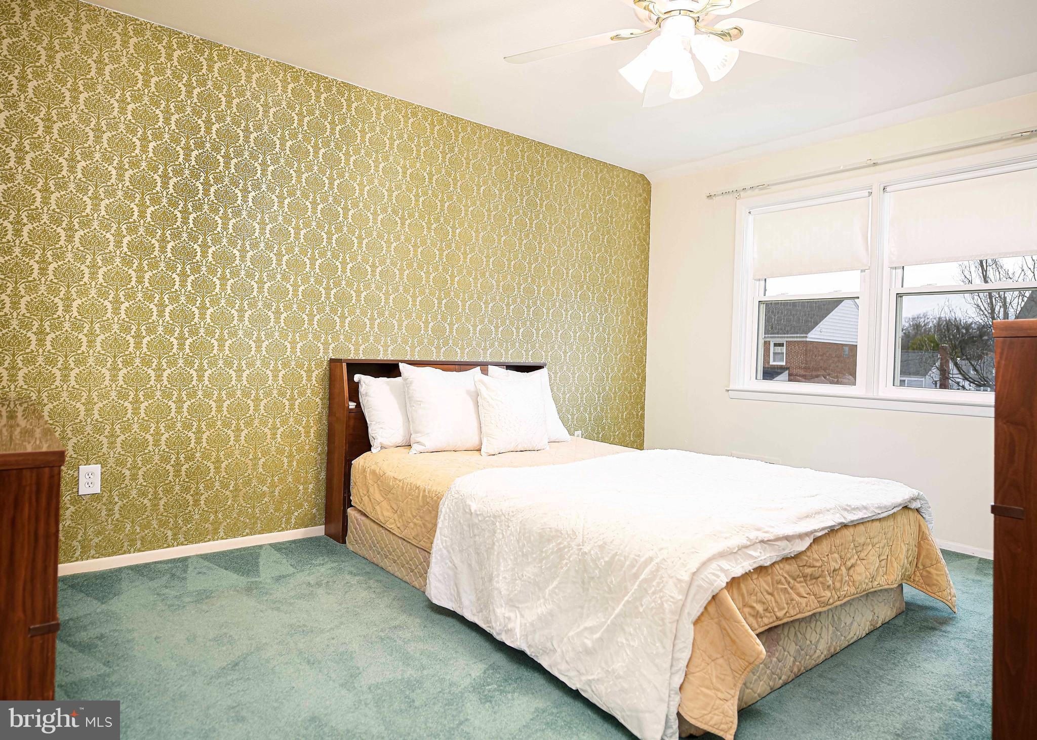 1131 Hollen Road Baltimore, MD 21239 - Photo 22 of 34 a bedroom with a bed and a painting on the wall