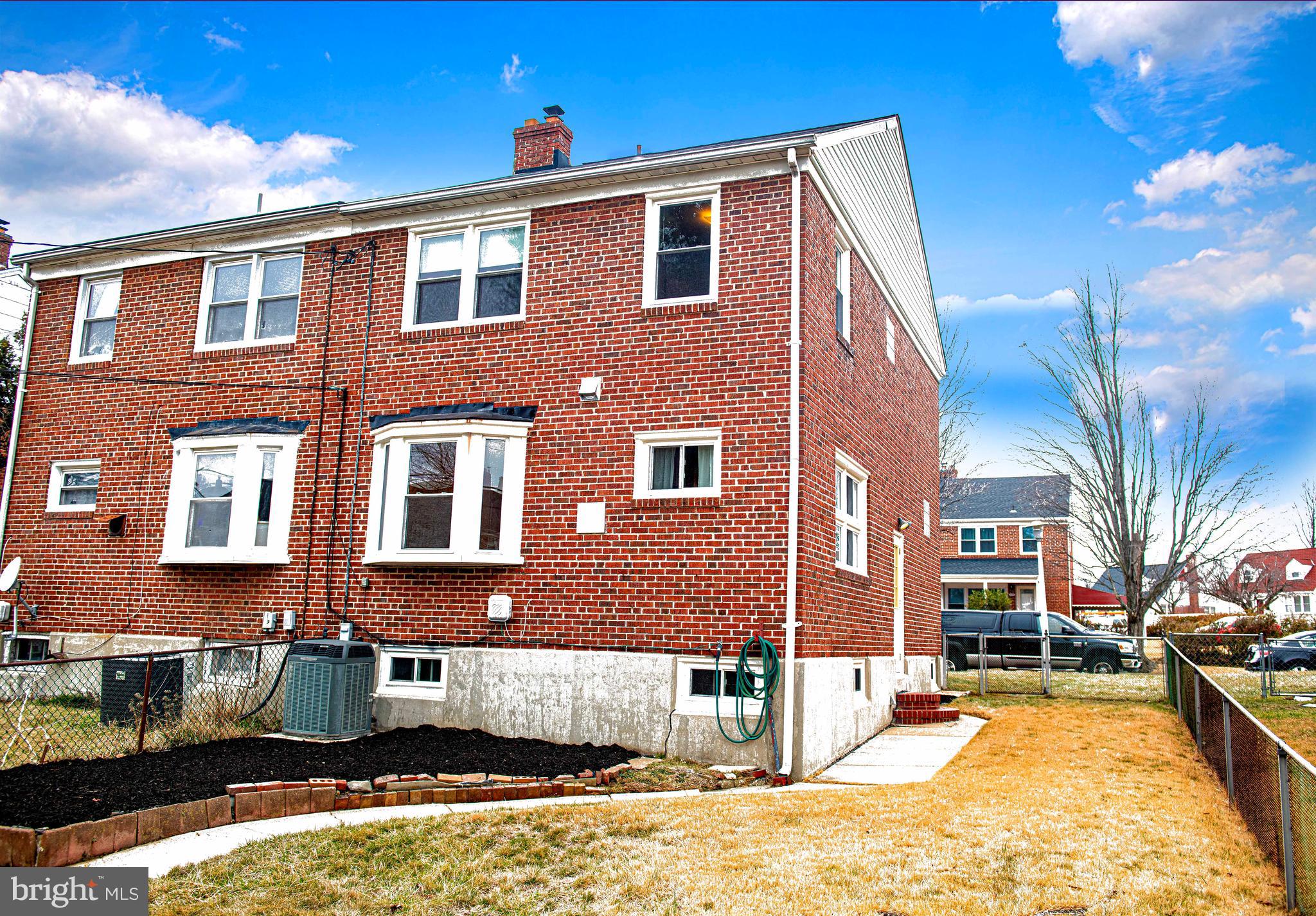 1131 Hollen Road Baltimore, MD 21239 - Photo 31 of 34 a front view of a house with a yard