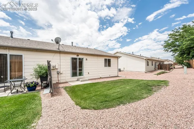 a front view of house with a garden