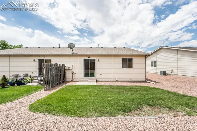 a view of a house with a yard and pathway