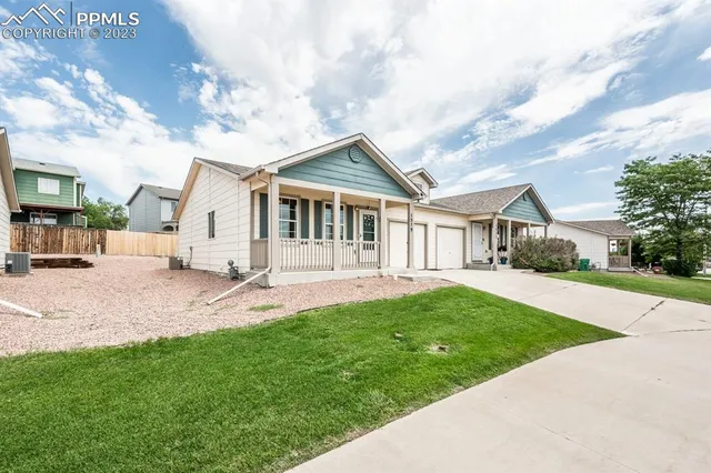 a front view of a house with a yard and porch