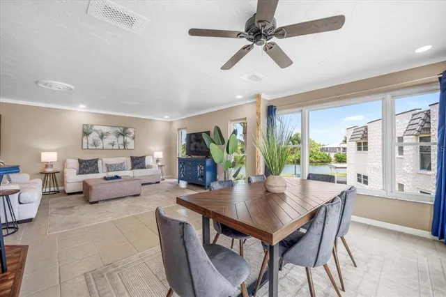 a living room with furniture a table and a large window