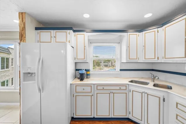 a kitchen with white cabinets and sink