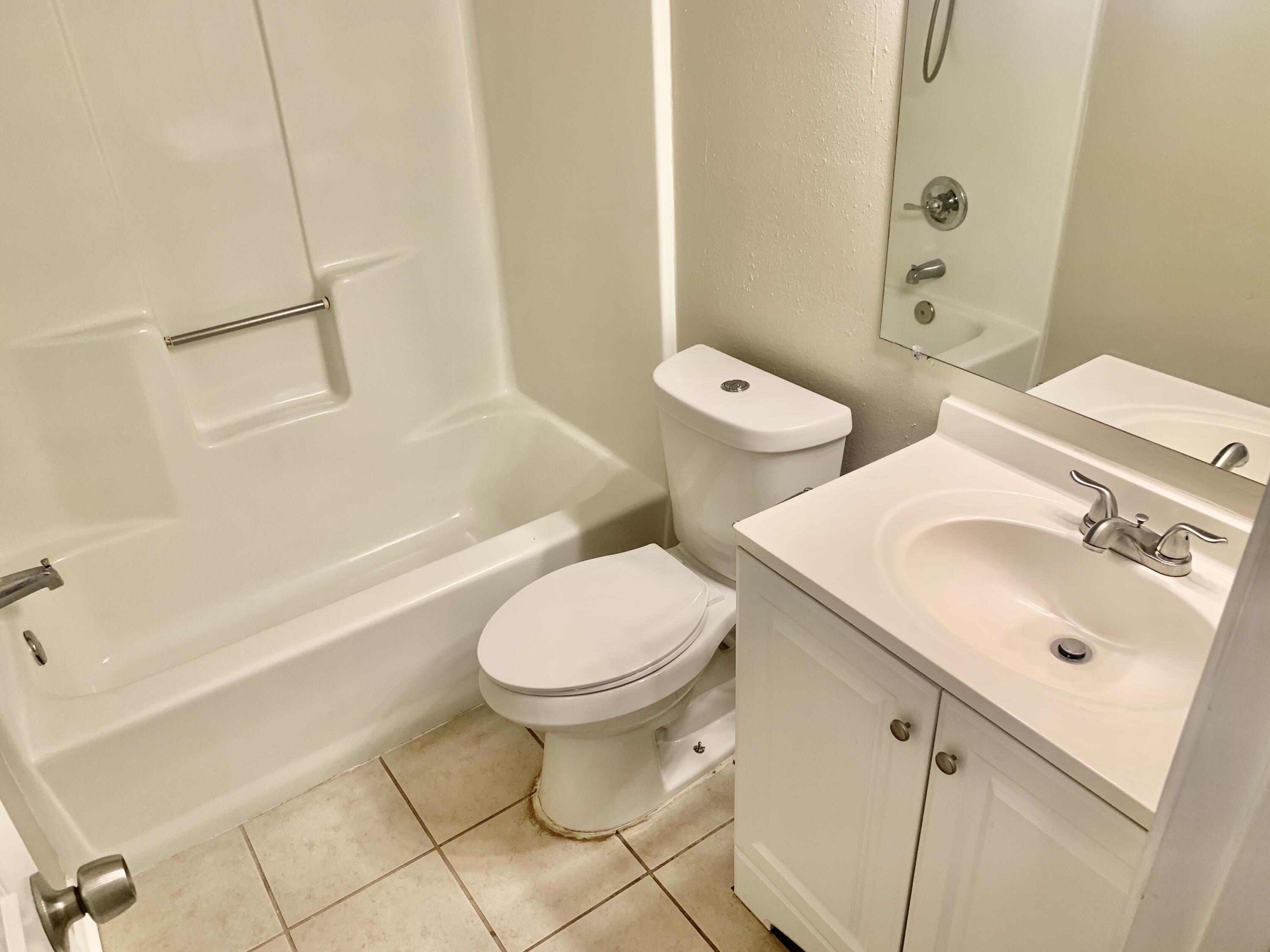122 West 1st Avenue Crestview, FL 32536 - Photo 13 of 15 a bathroom with a sink toilet and shower