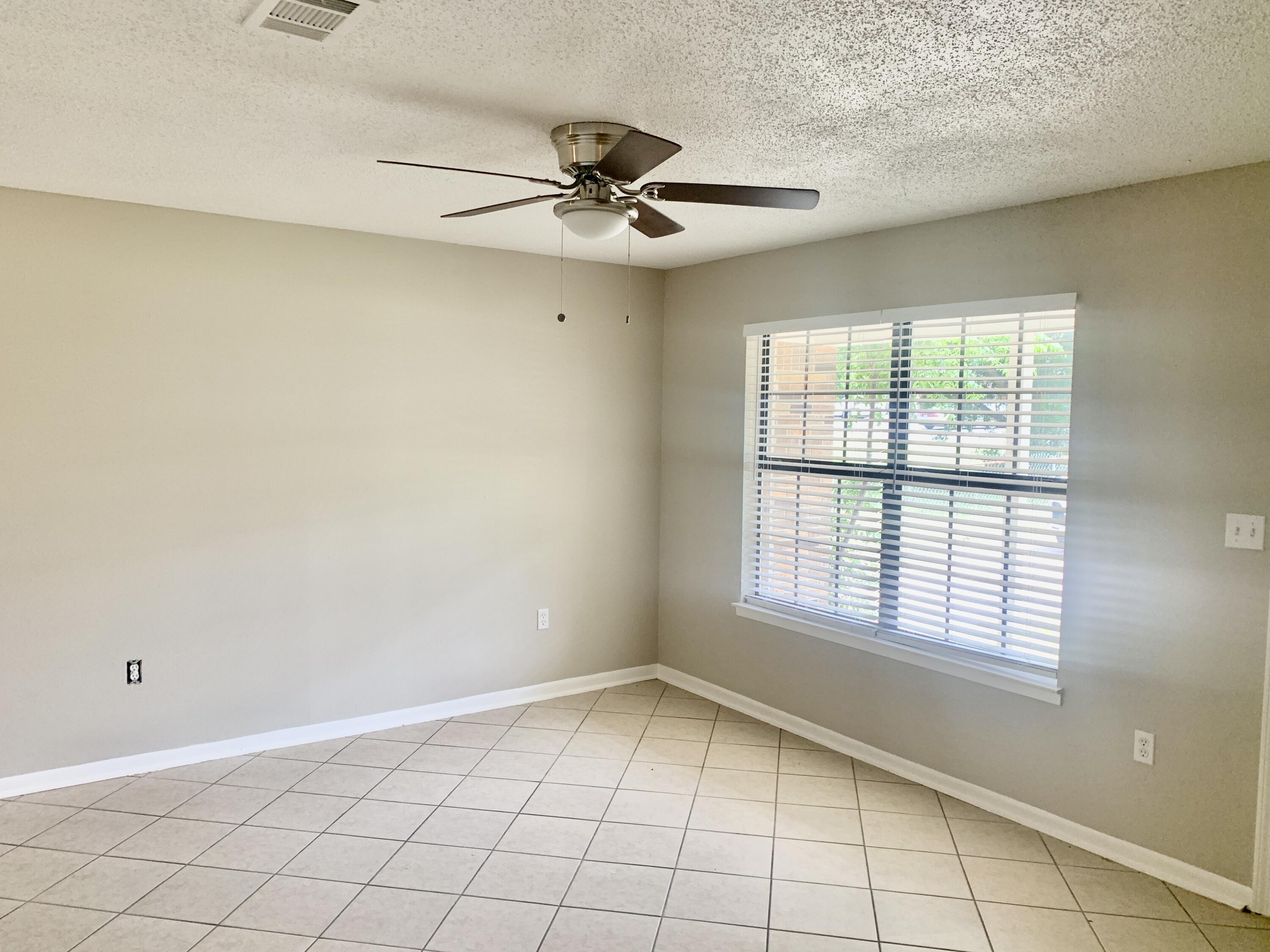 122 West 1st Avenue Crestview, FL 32536 - Photo 2 of 15 a view of an empty room with a window