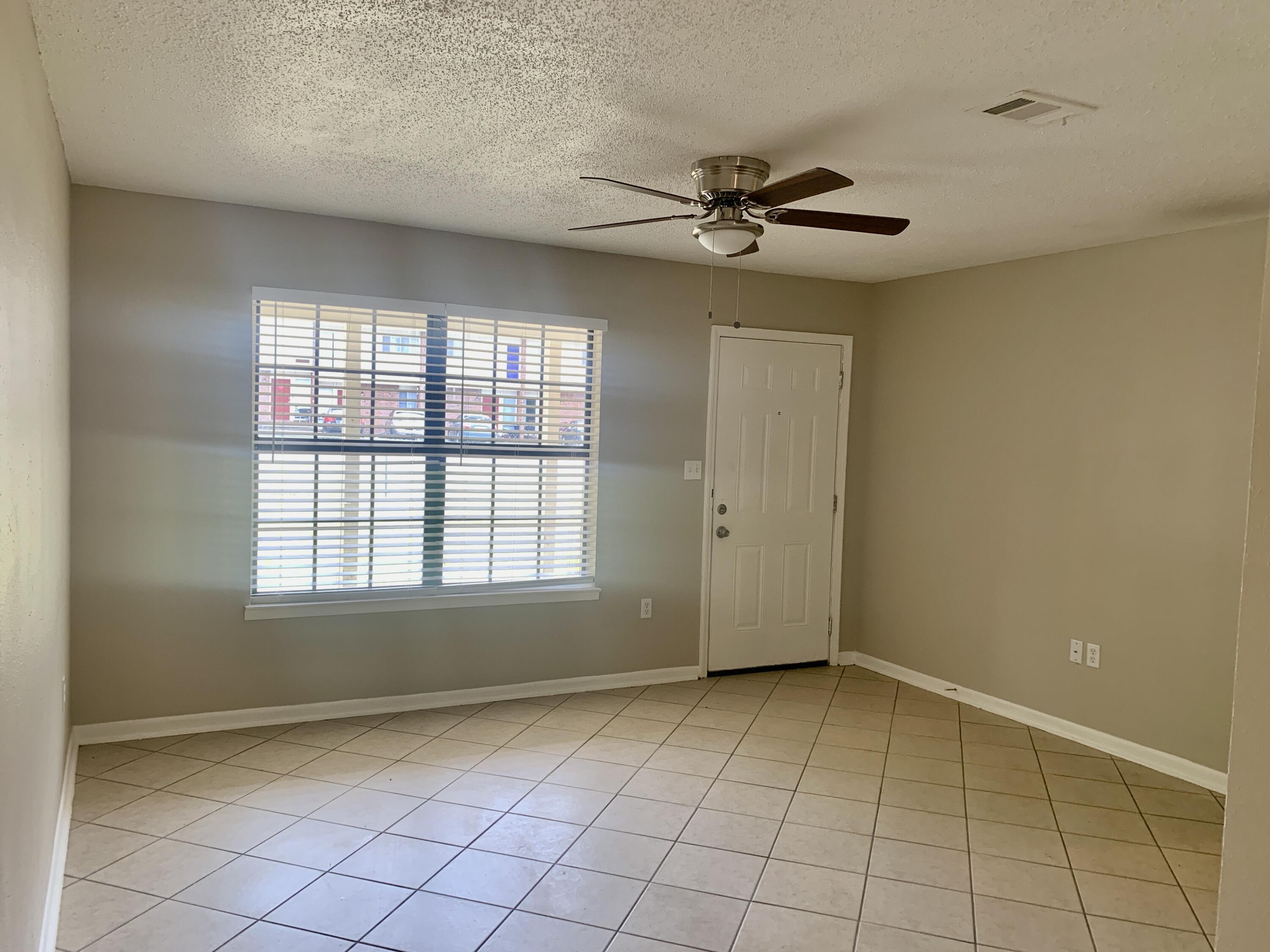 122 West 1st Avenue Crestview, FL 32536 - Photo 3 of 15 a view of an empty room with a window