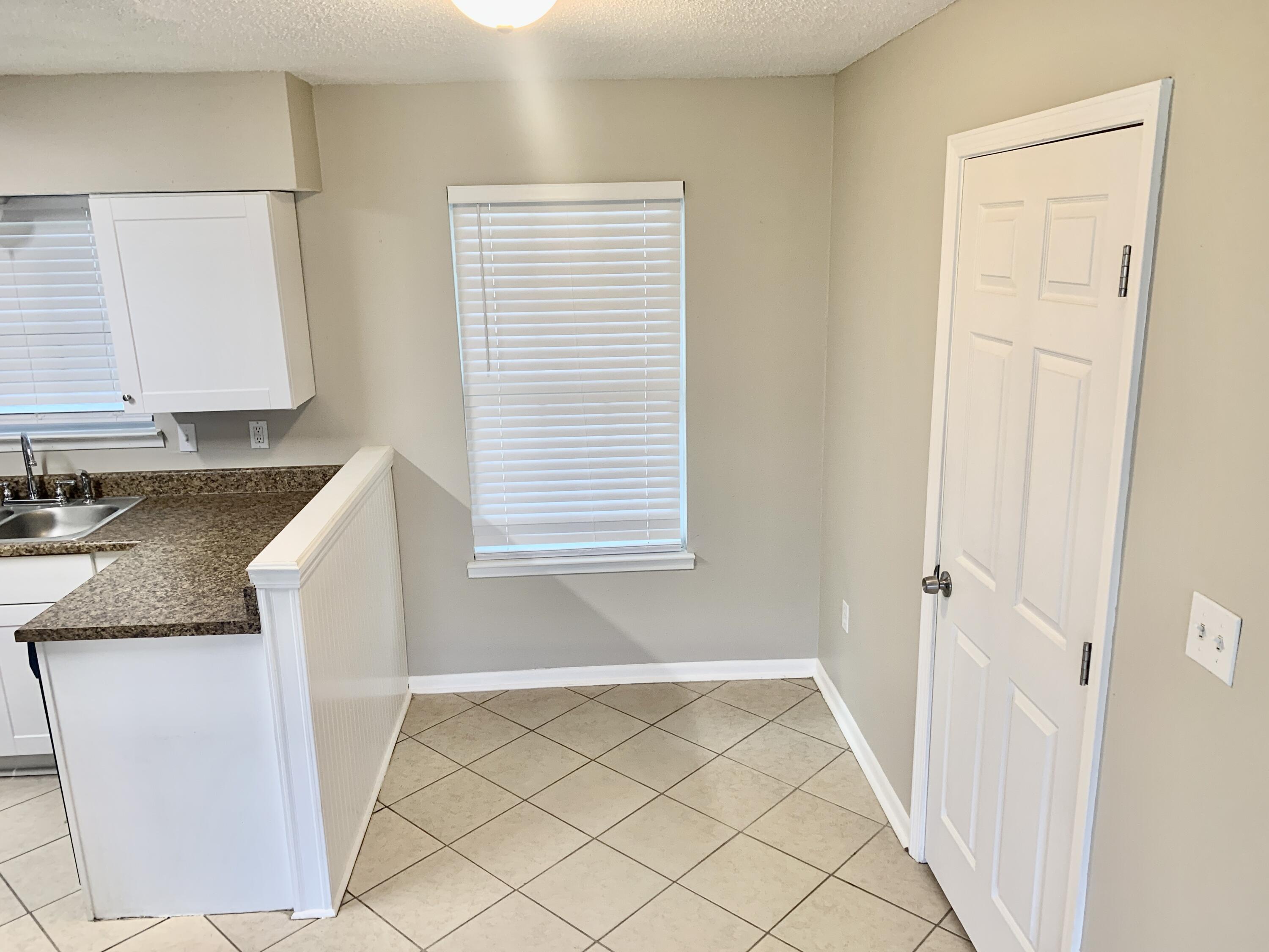122 West 1st Avenue Crestview, FL 32536 - Photo 7 of 15 a view of a kitchen cabinets and window