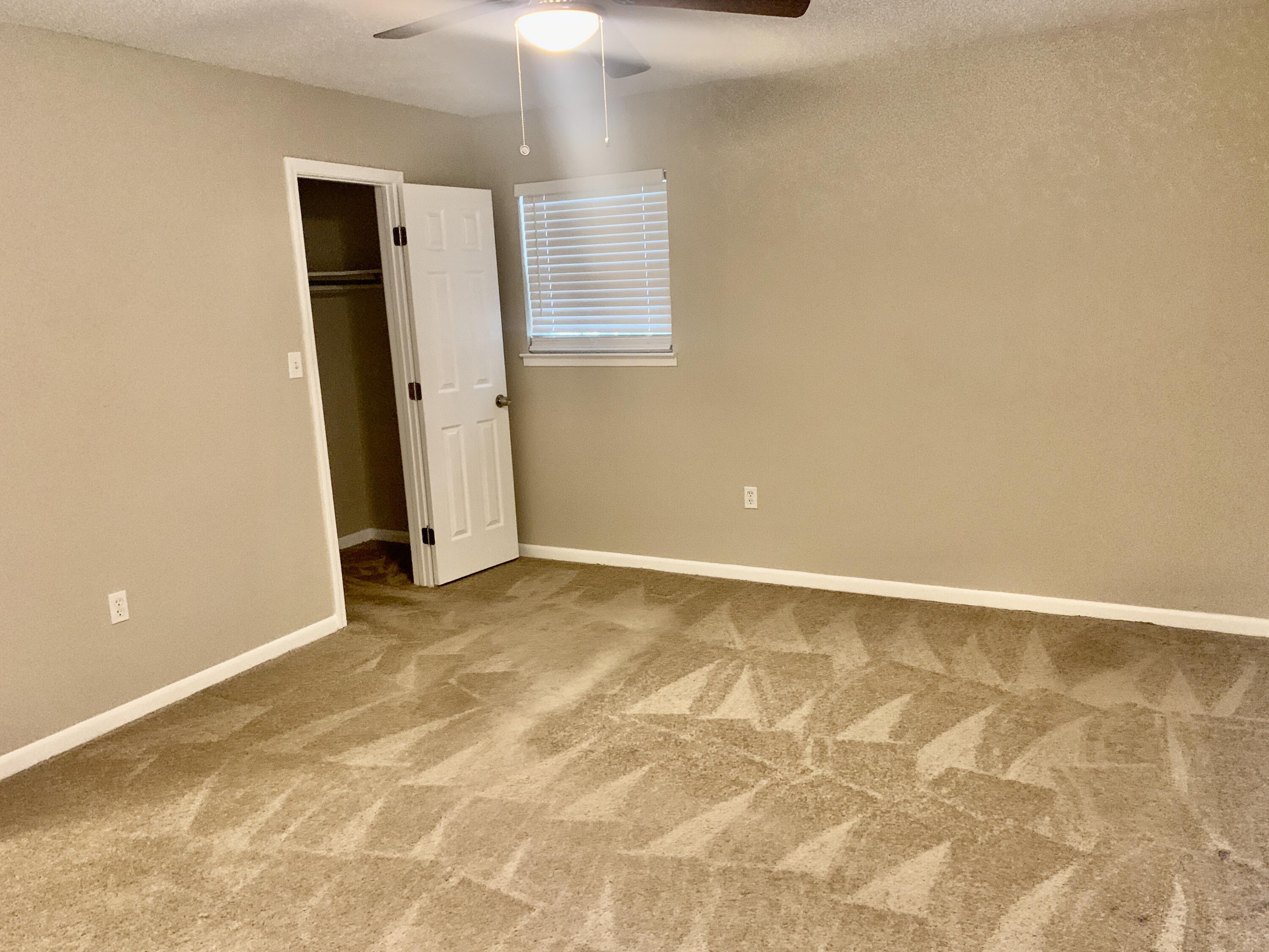 122 West 1st Avenue Crestview, FL 32536 - Photo 10 of 15 an empty room with a natural light