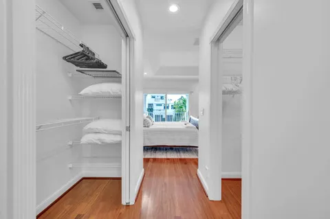 a view of hallway with wooden floor