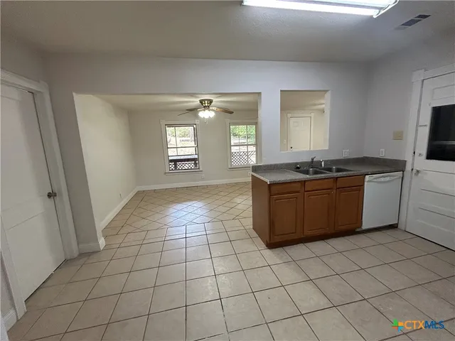 a kitchen with stainless steel appliances a sink stove and window