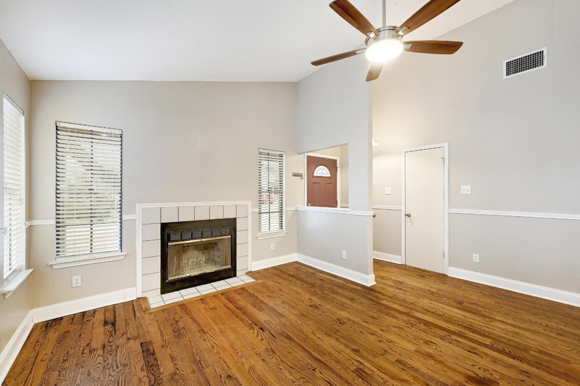 a view of an empty room with a fireplace and a window